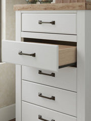 Benchcraft® Savonport five-drawer accent chest in white and brown with sleek drawer handles and modern design.