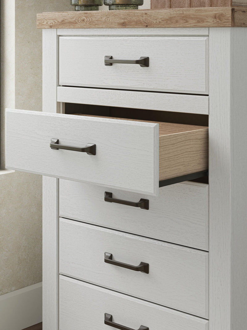 Benchcraft® Savonport five-drawer accent chest in white and brown with sleek drawer handles and modern design.