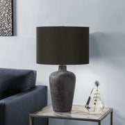 Contemporary black 8th Street table lamp with a sleek design, featuring a round base and cylindrical shade on a modern table.