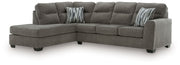 Benchcraft Olten stationary sectional sofa with plush cushions and modern design, shown in a cozy living room setting.