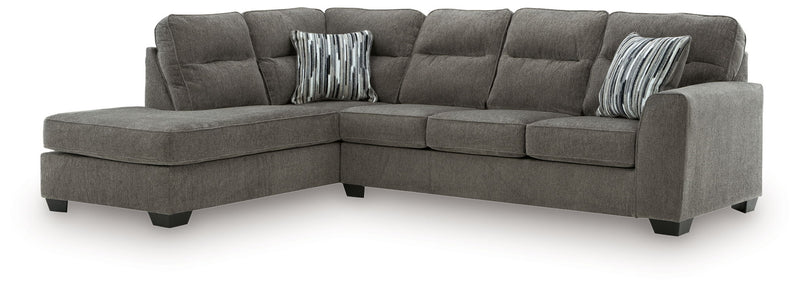 Benchcraft Olten stationary sectional sofa with plush cushions and modern design, shown in a cozy living room setting.