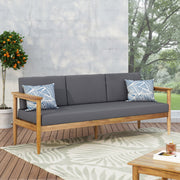 Dark gray outdoor 3 seater sofa with cushions and teak acacia wood frame by Noble House.
