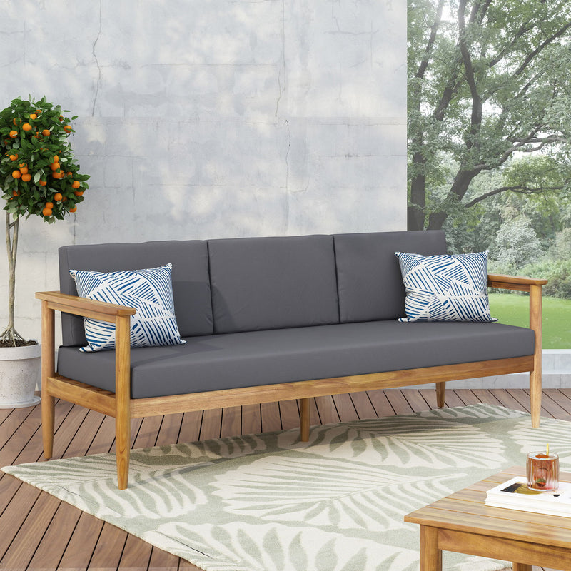 Dark gray outdoor 3 seater sofa with cushions and teak acacia wood frame by Noble House.