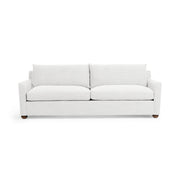 Olivia stationary sofa by Classic Home featuring plush beige fabric, wide armrests, and cushioned seating in a modern living room setting.