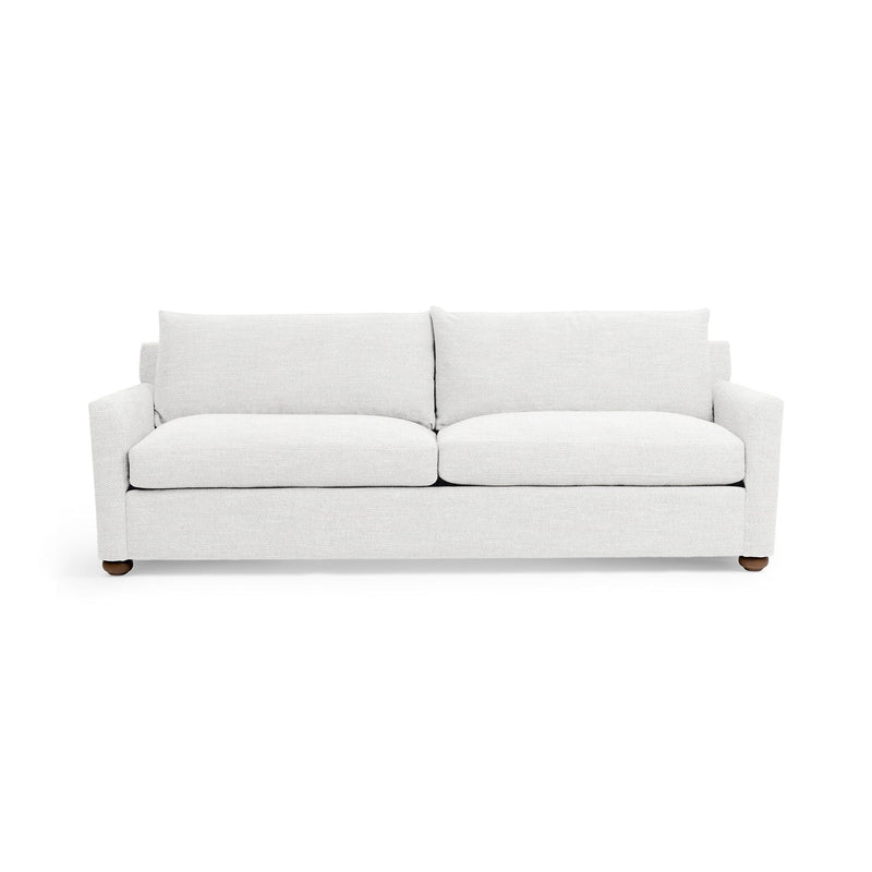 Olivia stationary sofa by Classic Home featuring plush beige fabric, wide armrests, and cushioned seating in a modern living room setting.
