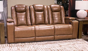 Signature Design by Ashley® Gruaro power reclining sofa with adjustable headrest in amber, showcasing plush cushions and modern recline features.