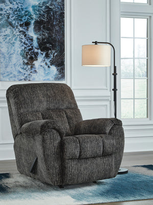 Signature Design by Ashley Stayfish rocker recliner with plush cushioning and wood arm accents, perfect for relaxing in a stylish rocker chair.
