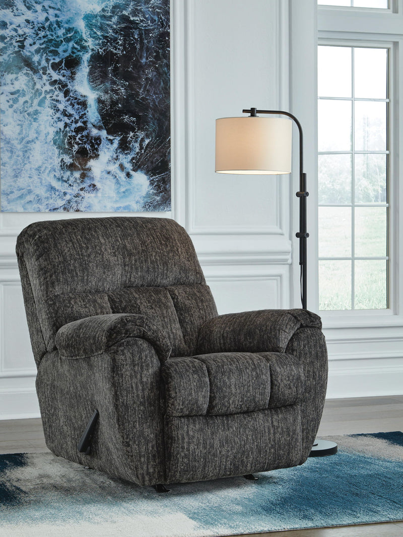 Signature Design by Ashley Stayfish rocker recliner with plush cushioning and wood arm accents, perfect for relaxing in a stylish rocker chair.