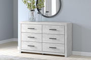 Whitewashed Cayboni dresser with six drawers by Signature Design by Ashley, featuring sleek modern design and silver handles.