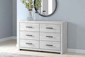 Whitewashed Cayboni dresser with six drawers by Signature Design by Ashley, featuring sleek modern design and silver handles.