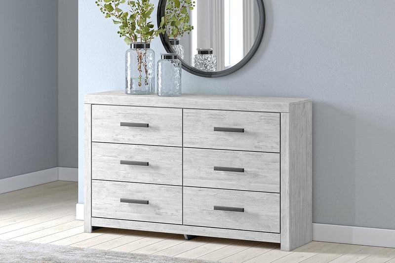 Whitewashed Cayboni dresser with six drawers by Signature Design by Ashley, featuring sleek modern design and silver handles.