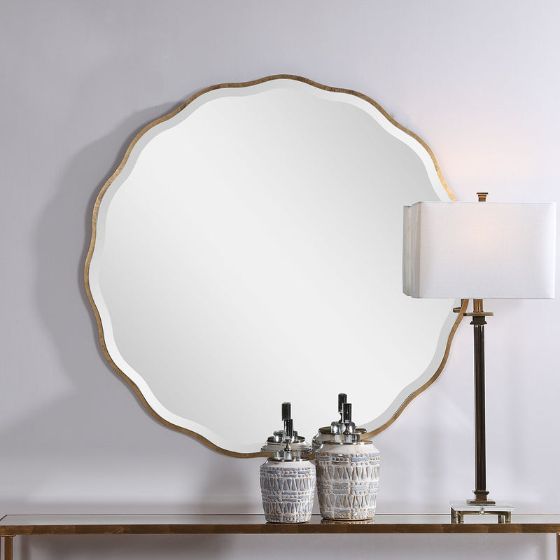 Uttermost Aneta round wall mirror with a sleek, modern frame hanging on a wall in a stylish home interior.