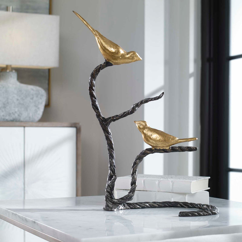 Black and gold Birds On A Limb sculpture by Uttermost featuring detailed bird figurines perched on a branch.