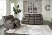 Signature Design by Ashley reclining living room sofa with plush cushions and extended footrest in a modern recliner sofa style.