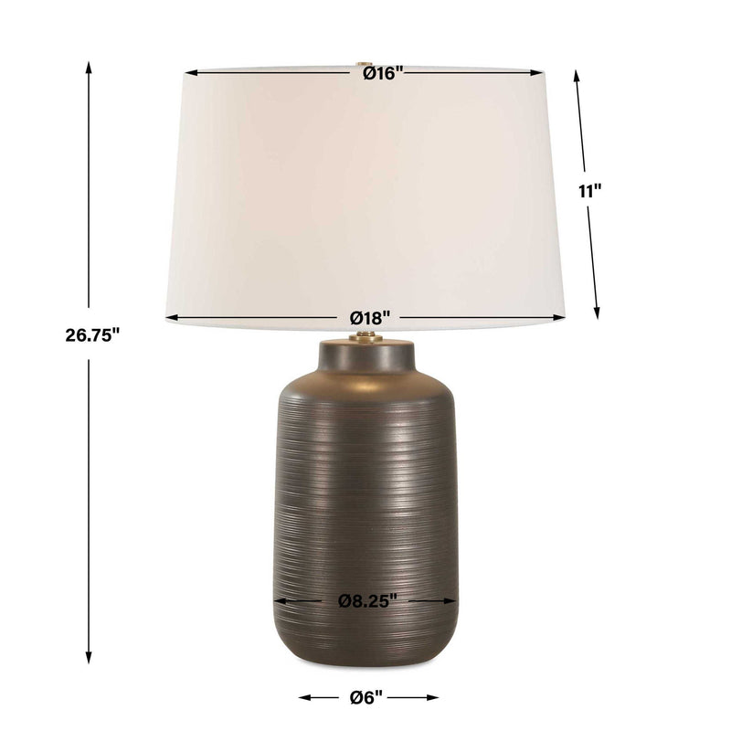 Uttermost Calderone bronze table lamp with a rounded base and fabric shade, perfect for modern or contemporary decor.