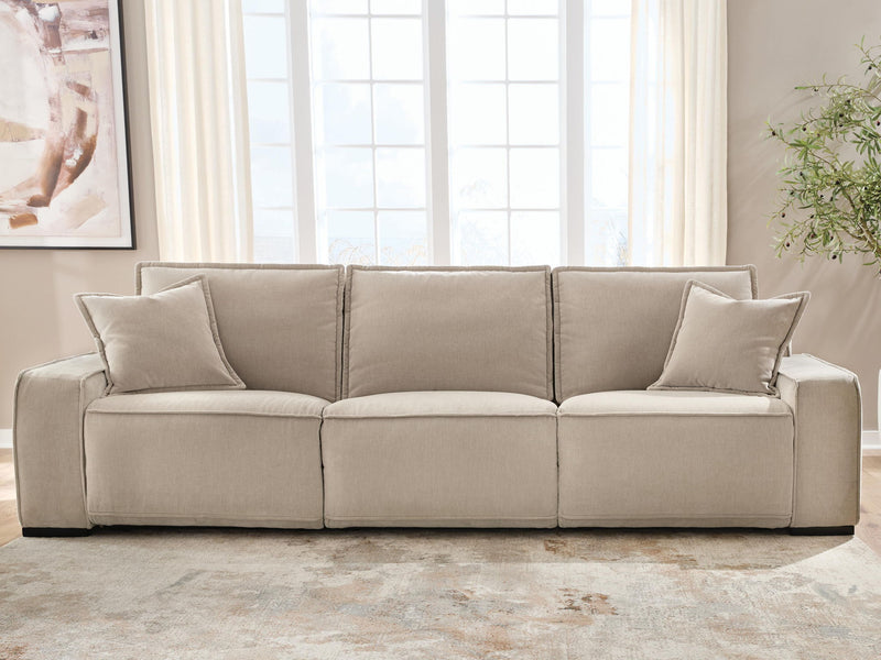 Benchcraft® Carceri reclining sectional with plush fabric, featuring multiple seats and adjustable reclining options in a modern living room setting.