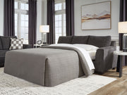 Benchcraft® Loreo sofa sleeper with plush fabric and convertible design, shown with unfolded bed in a modern living room setting.