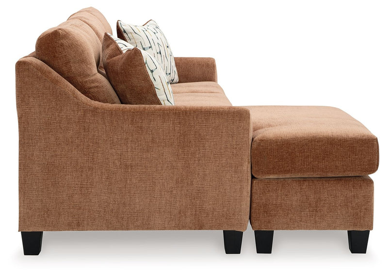 Benchcraft® Amity Bay sofa chaise sleeper with plush fabric, featuring a convertible design and comfortable seating.