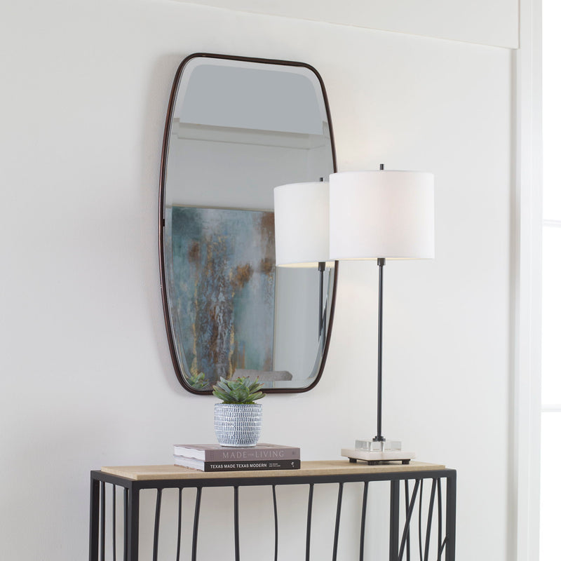 Uttermost Canillo wall mirror with a sleek, modern frame hanging on a neutral-colored wall.