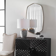 Uttermost Duronia iron wall mirror with a sleek, modern design and round frame, ideal for contemporary home decor.