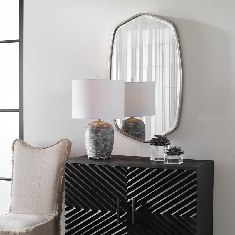 Uttermost Duronia iron wall mirror with a sleek, modern design and round frame, ideal for contemporary home decor.