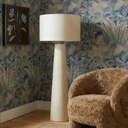 Cream papier mache Yala floor lamp by TOV Furniture with a sculptural, textured design standing upright in a modern setting.