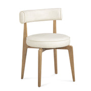 TOV Furniture Nikita dining side chair with sleek modern design and wooden legs, shown in a stylish home setting.