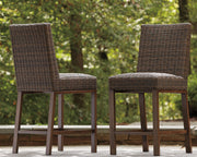 Set of two medium brown Paradise Trail barstools by Signature Design by Ashley, featuring wooden seats and metal legs.