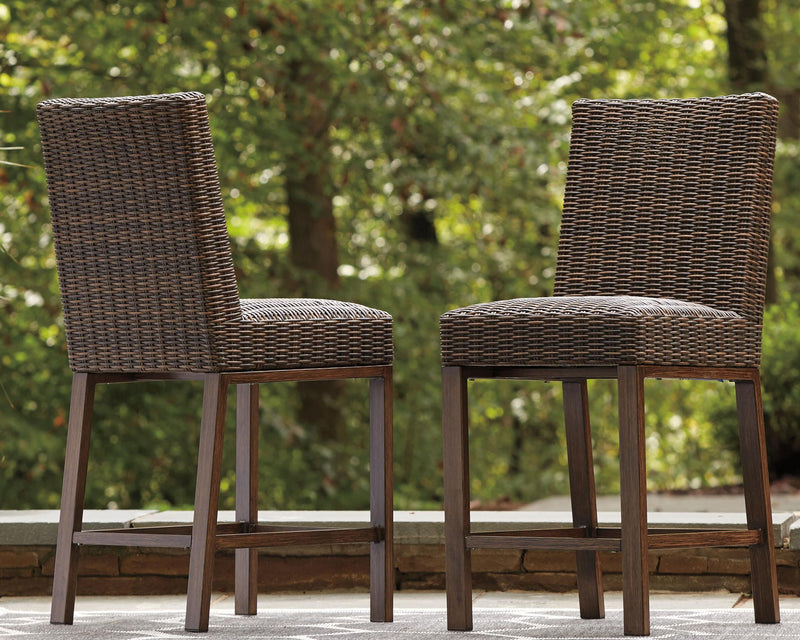 Set of two medium brown Paradise Trail barstools by Signature Design by Ashley, featuring wooden seats and metal legs.