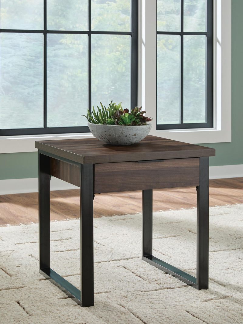 Signature Design by Ashley Wickman Falls rectangular cocktail table with a sleek wooden finish and modern design.