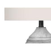 Modern gray and cream resin table lamp with sleek design, perfect for contemporary home decor by 8th Street.