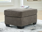 Benchcraft® Olten accent ottoman with soft fabric upholstery and a simple, modern design suitable for living room decor.