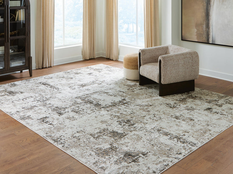 Signature Design by Ashley Barricland area rug featuring geometric patterns in neutral tones for modern home decor.
