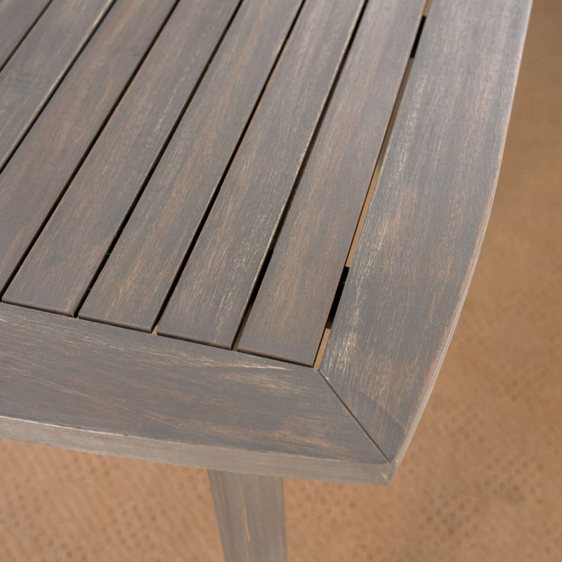 Modern indoor square dining table with acacia wood surface and toothpick leg design by Noble House.