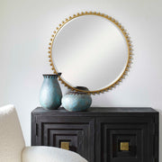 Round iron wall mirror by Uttermost with a minimalist design, featuring a sleek black frame and reflective surface.