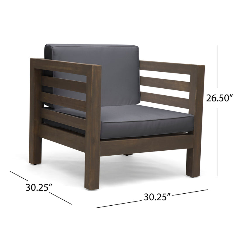 Noble House outdoor acacia wood patio arm chair with fabric cushion, showing a sturdy wooden frame and comfortable seating.