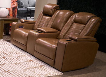 Signature Design by Ashley Gruaro power reclining loveseat with console, adjustable headrest, in amber fabric, showing plush cushions