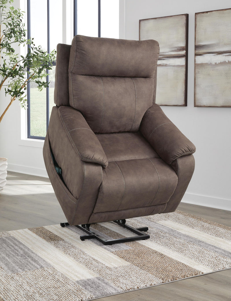 Signature Design by Ashley Crestmeade Power Lift Recliner in plush fabric with padded armrests and ergonomic design.