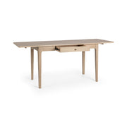Classic Home Karl extendable coastal drift writing desk with sleek wood finish and adjustable length.