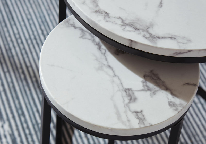 Set of four black and white nesting tables by Signature Design, featuring modern, space-saving tables perfect for versatile living spaces.