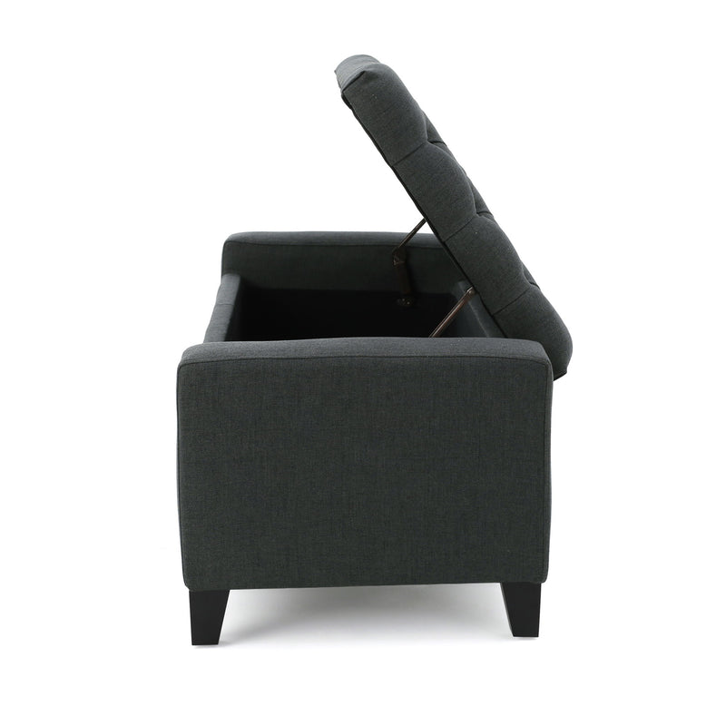 Dark gray Noble House storage ottoman with a tufted top, showcasing a contemporary design and plush cushioning.