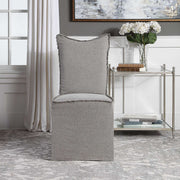 Set of two gray Narissa armless chairs by Uttermost, with sleek modern design and upholstered fabric seats.