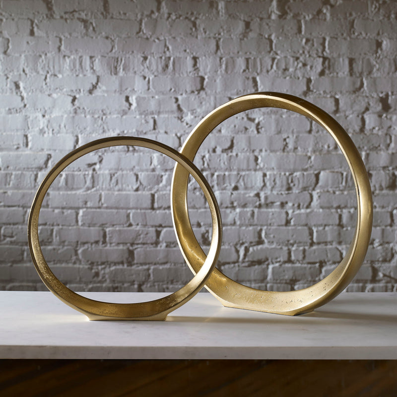 Gold Jimena ring sculptures set of 2 by Uttermost, decorative figurines with elegant, modern design for home decor.