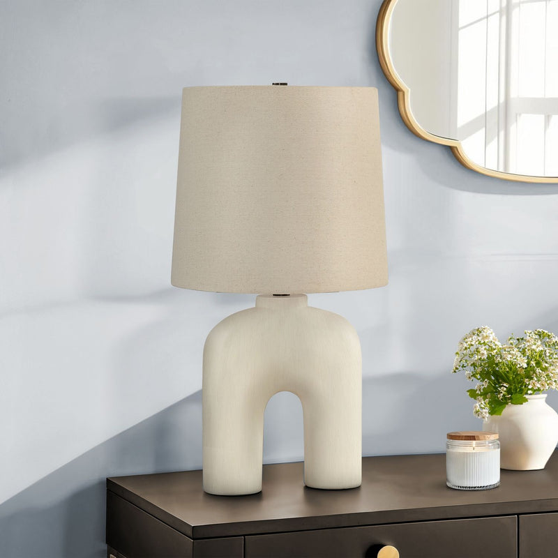 Cream resin modern table lamp by 8th Street with a sleek, minimalist design perfect for contemporary home decor.