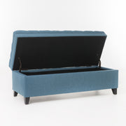 Noble House Juliana storage ottoman with birch wood legs, cushioned top, and spacious interior for versatile living room storage.