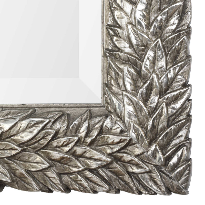 Uttermost Evelina Leaves Silver Wall Mirror with intricate leaf design, framed in polished silver for elegant wall decor.