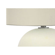 Contemporary cream ceramic table lamp with a sleek design, perfect for modern living spaces, by 8th Street.