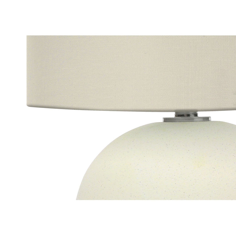 Contemporary cream ceramic table lamp with a sleek design, perfect for modern living spaces, by 8th Street.