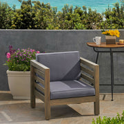 Noble House outdoor acacia wood patio arm chair with fabric cushion, featuring a sturdy frame and comfortable seating for outdoor spaces.
