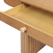 Jennifer Taylor Home Jesse single drawer fluted oval console desk in honey brown wood with tapered legs.